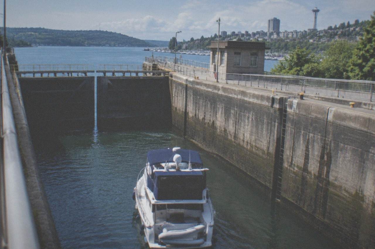 Ballard Locks gates and walkway above a pleasure boat waiting in the chamber