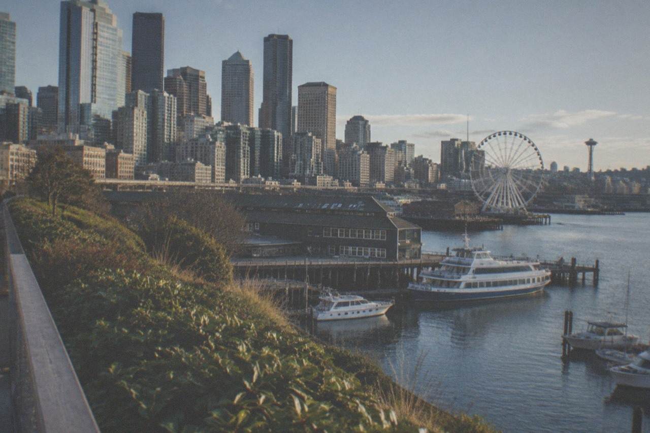 Seattle waterfront piers along Elliott Bay with moored boats and downtown skyline above