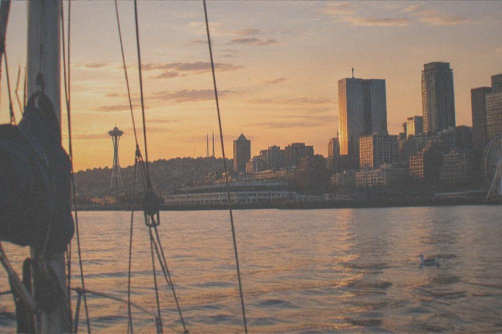 Seattle sunset over the city skyline seen from the water with warm light on buildings